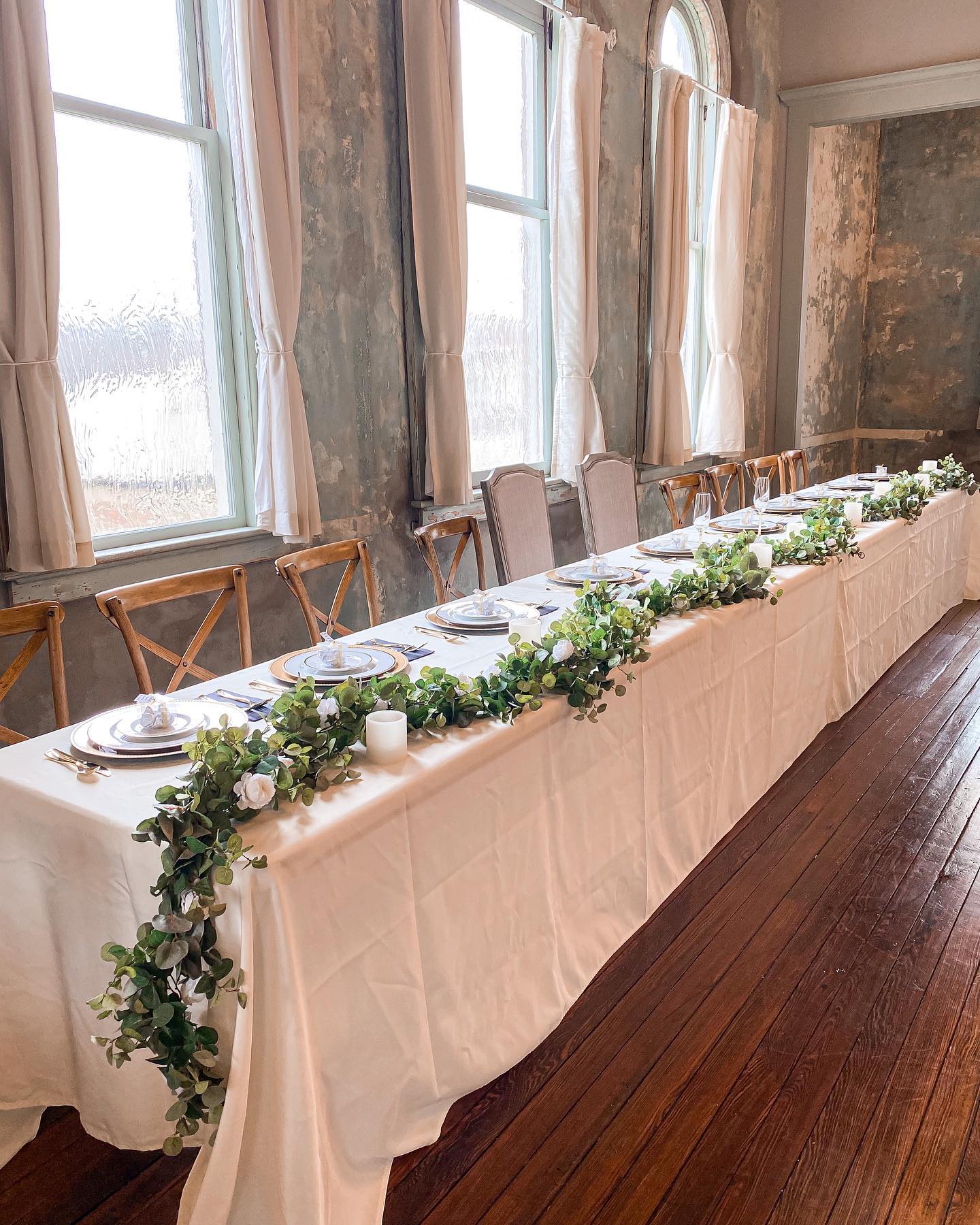 wedding reception table with simple greenery table runner
