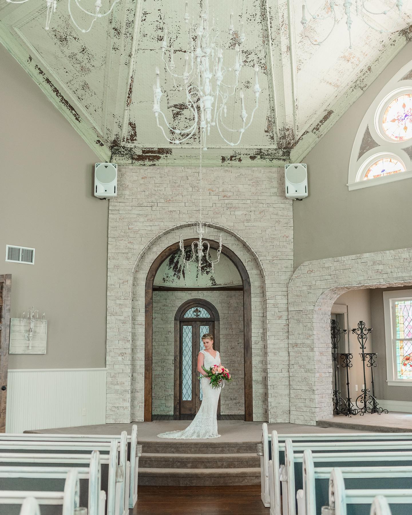 bride posing at altar in historic church venue