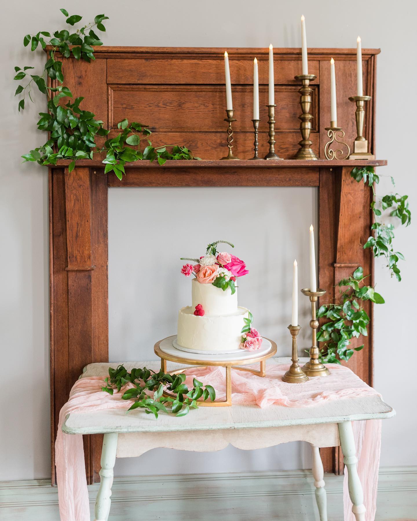 wedding cake in front of wooden mantle