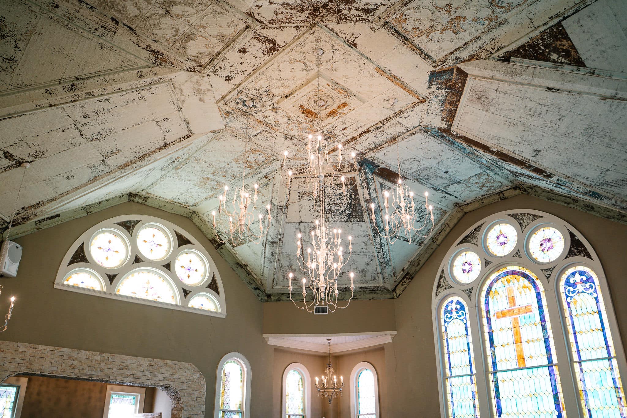chandeliers and stained glass windows inside the 1906