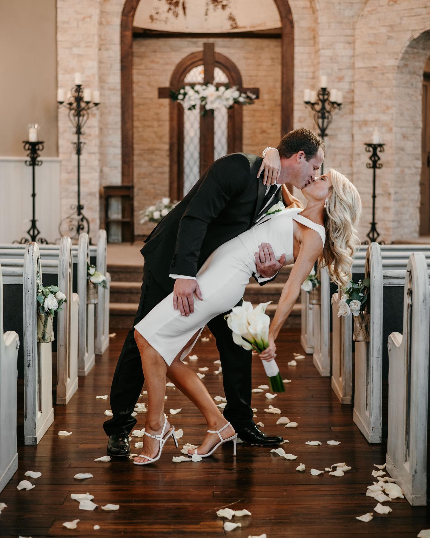 couple kissing in aisle historic church