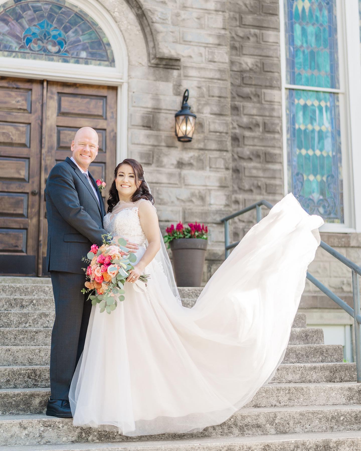 bride with flowing gown and groom outside the 1906