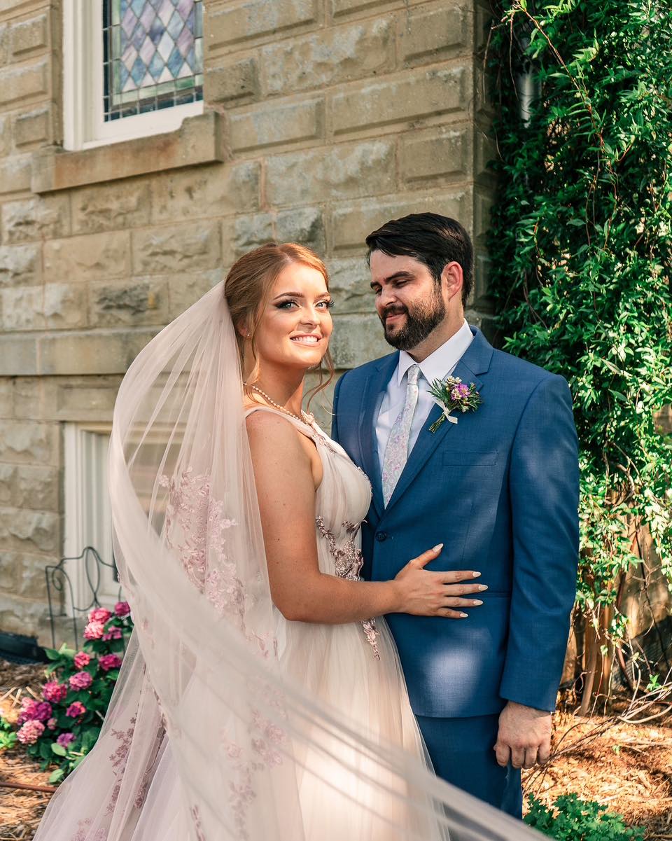 bride and groom posing outside the 1906 venue